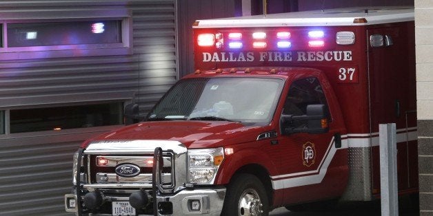 An ambulance pulls into the Dallas Fire-Rescue station 37 in Dallas, Wednesday, Oct. 1, 2014. Three EMT's from this location are under a 21 day quarantine after a patient they transported tested positive for Ebola. (AP Photo/LM Otero)