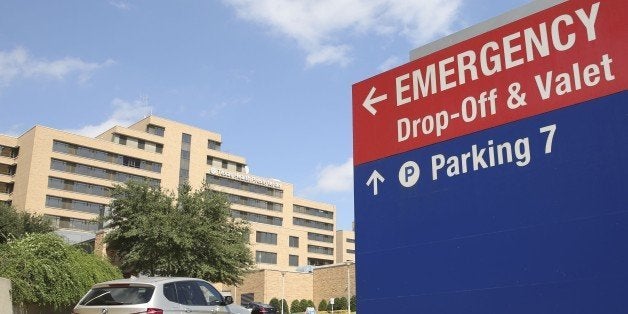 A vehicle drives up the driveway to the Texas Health Presbyterian Hospital in Dallas, Tuesday, Sept. 30, 2014. A patient in the hospital is being teated for Ebola. (AP Photo/LM Otero)