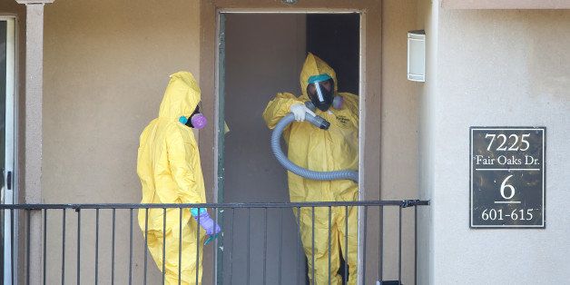 DALLAS, TX - OCTOBER 06: Members of the Cleaning Guys Haz Mat clean up company are seen as they sanitize the apartment where Ebola patient Thomas Eric Duncan was staying before being admitted to a hospital on October 6, 2014 in Dallas, Texas. The first confirmed Ebola virus patient in the United States was staying with family members at The Ivy Apartment complex before being treated at Texas Health Presbyterian Hospital Dallas. State and local officials are working with federal officials to monitor other individuals that had contact with the confirmed patient. (Photo by Joe Raedle/Getty Images)