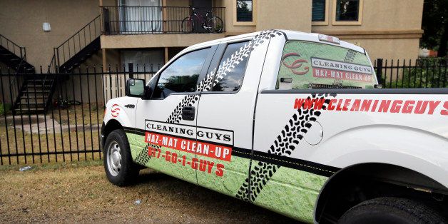 File - In the Oct. 2, 2014, file photo, a hazardous materials cleaning company truck sits parked outside The Ivy Apartments in Dallas. A 15-member crew from the Cleaning Guys of Fort Worth labored for four days at the apartment where Thomas Eric Duncan stayed when he began showing Ebola-related symptoms such as vomiting and diarrhea. They suited up in yellow protective suits with black gas masks and filled about 140 barrels with items from the home for incineration, including mattresses, the patientￃﾢￂﾀￂﾙs sheets and the entire carpet. (AP Photo/Tony Gutierrez, File)