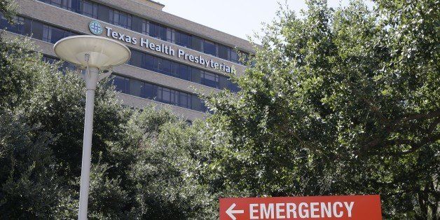A sign points to the emergency room at Texas Health Presbyterian Hospital where Thomas Eric Duncan, the Ebola patient who traveled from Liberia to Dallas, is being treated Saturday, Oct. 4, 2014, in Dallas. Duncan remains in isolation, where he was listed in critical condition Saturday. At the end of the week, Texas health officials said they had narrowed to about 50 the group of people they were monitoring who had some exposure to Duncan. (AP Photo/LM Otero)