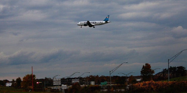 CLEVELAND, OHIO - OCTOBER 15: A Frontier Airlines plane lands at Cleveland Hopkins Airport on October 15, 2014 in Cleveland, Ohio. Recently diagnosed Ebola patient, health care worker Amber Vinson, traveled on Frontier Airlines from Dallas to Cleveland with a low fever on October 10, and returned to Dallas on October 13. The aircraft has since been decontaminated and put back in service. Nurse Amber Vinson joins Nina Pham as health workers who have contracted the Ebola virus at Texas Heath Presbyterian Hospital while treating patient Thomas Eric Duncan, who has since died. (Photo by Michael Francis McElroy/Getty Images)