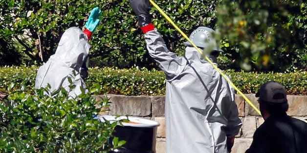 DALLAS, TX - OCTOBER 16: Two hazmat workers prepare to enter The Village Bend East apartment complex where a second health care worker who has tested positive for the Ebola virus resides on October 16, 2014 in Dallas, Texas. Nurse Amber Vinson joins Nina Pham as health workers who have contracted the Ebola virus at Texas Heath Presbyterian Hospital while treating patient Thomas Eric Duncan, who has since died. (Photo by Mike Stone/Getty Images)