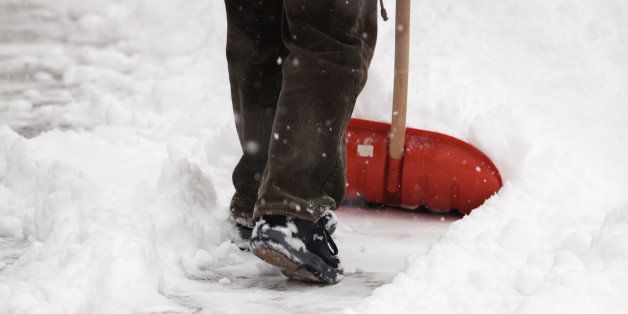 man shoveling snow from the...