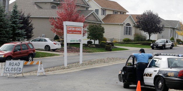 Police keep watch on a home Thursday, Oct. 16, 2014 in Tallmadge, Ohio where Amber Joy Vinson stayed over the weekend before flying home to Dallas. At least seven people in northeast Ohio are under voluntary quarantine and being monitored because they had contact with Vinson, a Texas nurse who was diagnosed with Ebola shortly after visiting the area last weekend, health officials said Thursday. (AP Photo/Tony Dejak)