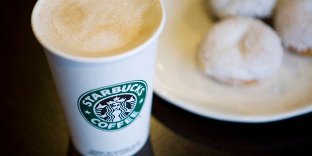 A Starbucks Corp. new low calorie vanilla latte and mini sparkle doughnuts are arranged for a photograph in New York, U.S., on Wednesday, Jan. 13, 2010. New Yorkers were more inclined to buy coffee from Starbucks Corp., especially from stores near a Dunkin' Donuts outlet, after restaurant chains were required to display calorie counts on products, researchers found. Photographer: Ramin Talaie/Bloomberg via Getty Images