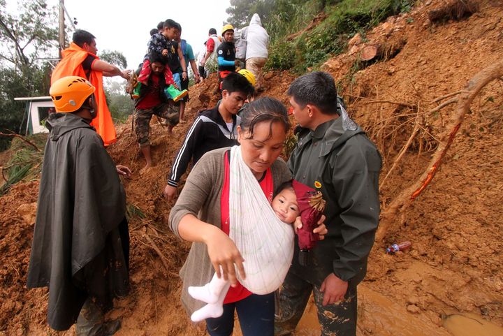 Families and relatives of miners move to safer grounds after massive landslides triggered by Super Typhoon Mangkhut in Itogon town, Benguet province on September 16, 2018. (JJ LANDINGIN/AFP/Getty Images)