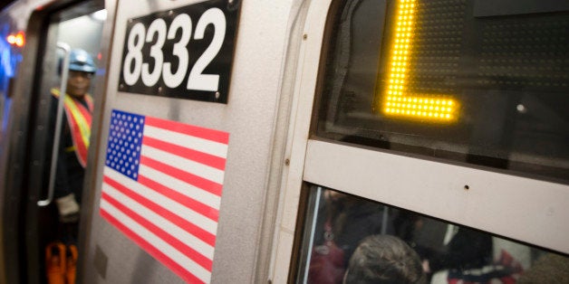 Riders stand inside an L-Train subway car, Thursday, Oct. 23, 2014, in New York. Craig Spencer, a Doctors Without Borders physician who tested positive for the Ebola virus after treating Ebola patients in West Africa, had taken the train after visiting a bowling alley in Williamsburg. (AP Photo/John Minchillo)