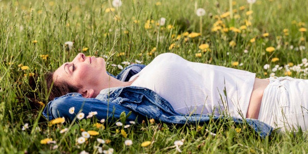 beautiful girl lying down on grass. Copy space.