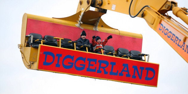 UNITED KINGDOM - DECEMBER 20: Young visitors to Diggerland enjoy a ride on a spinning JCB arm, near Rochester in Kent,Tuesday, December 20, 2005. For children or adults, operating full-scale machinery, is the key attraction of the 24-acre dirt park, about an hour's drive south of London in Kent. (Photo by Graham Barclay/Bloomberg via Getty Images)