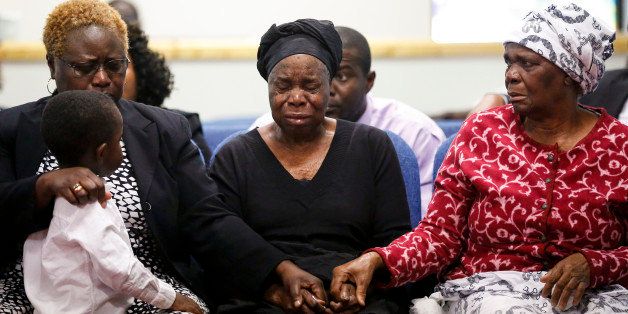 Garteh Korkoryah, center, mother of Thomas Eric Duncan, is comforted during a memorial service for her son, Saturday, Oct. 18, 2014, in Salisbury, N.C. Duncan died of Ebola in Dallas on Oct. 8. (AP Photo/Nell Redmond)