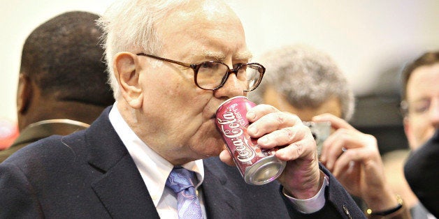 Warren Buffett, chief executive officer of Berkshire Hathaway, drinks a Cherry Coca-Cola as he tours the exhibition floor prior to the Berkshire Hathaway annual meeting in Omaha, Nebraska, U.S., on Saturday, May 1, 2010. Buffett, the Wall Street critic who invested $5 billion in Goldman Sachs Group Inc., said he supports the bank's Chief Executive Officer Lloyd Blankfein '100 percent' after the firm was sued by regulators for fraud. Photographer: Daniel Acker/Bloomberg via Getty Images