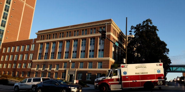 OMAHA, NEBRASKA - OCTOBER 6: An ambulance carrying an American freelance cameraman who contracted Ebola in Liberia, Ashoka Mukpo, arrives at the Nebraska Medical Center October 6, 2014 in Omaha, Nebraska. Mukpo is the fifth American diagnosed with Ebola and is reported to be in good spirits. (Photo by Eric Francis/Getty Images)