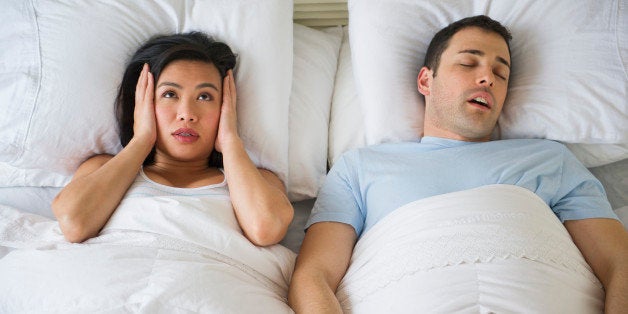 USA, New Jersey, Jersey City, Couple in bed, man snoring
