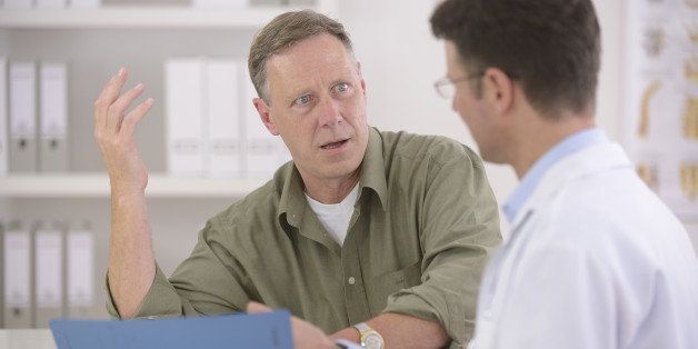 Doctor talking to mature male patient