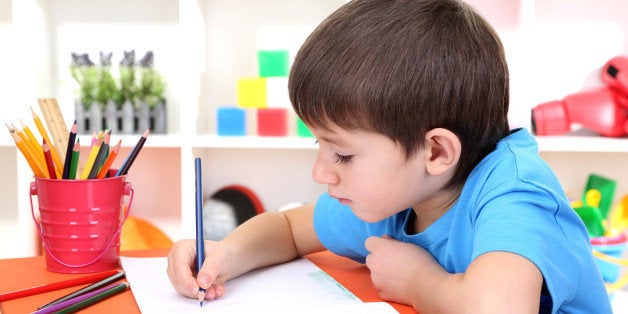 cute little boy drawing in his...