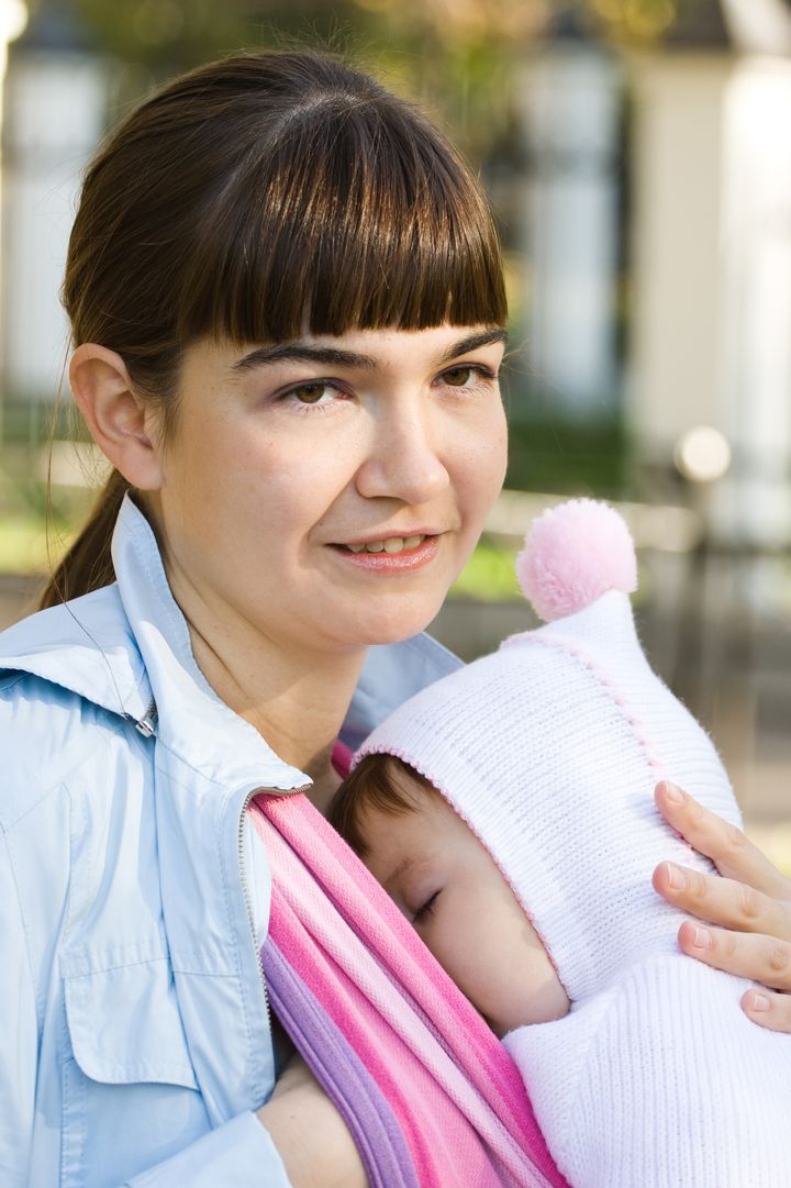 Walk with the child in a baby sling. Breastfeeding