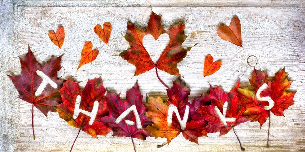 Thanksgiving day concept/Autumn thanksgiving day background with red and yellow leaves with word "Thanks" /Autumn leaves over wooden background 