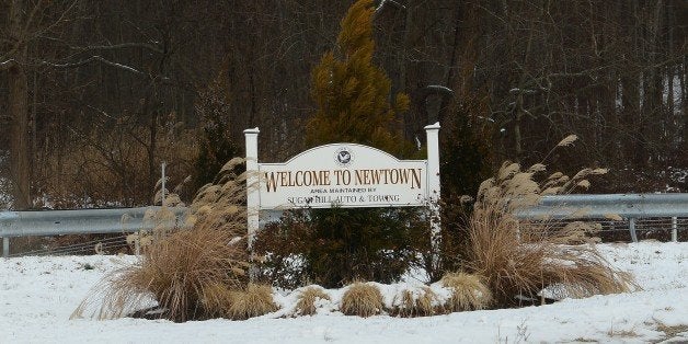 A sign welcomes people in Newtown, Connecticut, on December 13, 2013. Families ask media outlets to stay away in respect of their need to be alone to mark the one year anniversary, on December 14, during which 20-year-old gunman Adam Lanza went on a rampage at Sandy Hook elementary school, killing 20 children and six adults before turning a gun on himself. It appears that virtually all major US cable and network news organizations do not plan to have a presence in Newtown. AFP PHOTO/Emmanuel Dunand (Photo credit should read EMMANUEL DUNAND/AFP/Getty Images)