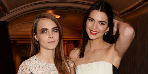 LONDON, ENGLAND - DECEMBER 01: Kendall Jenner (R) and Model of the Year winner Cara Delevingne attend the British Fashion Awards at the London Coliseum on December 1, 2014 in London, England. (Photo by David M. Benett/Getty Images)