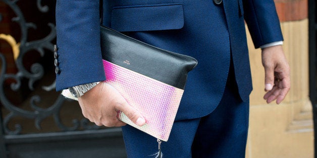 LONDON, ENGLAND - JUNE 16: Fashion Writer Tahmo Ogasawara wears a bespoke suit and Celine clutch on day 2 of London Collections: Men on June 16, 2014 in London, England. (Photo by Kirstin Sinclair/Getty Images)