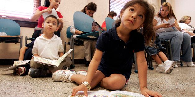 Carla Silvestre, 4, and Frankie Galarza, 4, left rear sitting, follow along as they read through a nutrition booklet while attending a nutrition education class at the Dallas County WIC office in Dallas, Wednesday, Sept. 6, 2006. Dallas County's WIC office, which provides food stamps, help with healthcare and education to new and expectant mothers, gave its first class aimed at curbing the nation's rising obesity rates from the very start. (AP Photo/Tony Gutierrez)