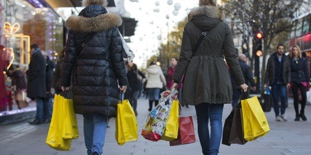 People walk along Oxford Street with carrier bags full of shopping in central London on December 8, 2014. AFP PHOTO/JUSTIN TALLIS (Photo credit should read JUSTIN TALLIS/AFP/Getty Images)