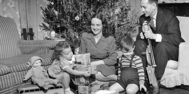 UNITED STATES - CIRCA 1950s: Family sitting in front of Christmas tree. (Photo by George Marks/Retrofile/Getty Images)