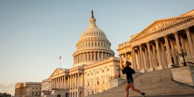 A jogger runs past the United States Capitol building at sunrise in Washington, D.C., U.S., on Tuesday, Oct. 15, 2013. Senate leaders are poised to reach an agreement as early as today to bring a halt to the fiscal standoff, and now must race the clock to sell the plan to lawmakers before U.S. borrowing authority runs out this week. Photographer: Pete Marovich/Bloomberg via Getty Images