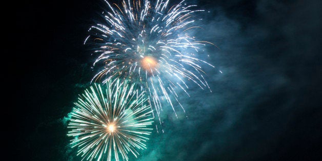 Gorgeous green, blue and purple fireworks against a cloud of smoke that looks like the Milky Way. The sort of thing you would see at New Year's, July 4th or other public holidays.