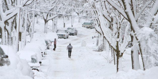 MADISON, WI - DECEMBER 9: A runner makes her way down a snowy street doing errends December 9, 2009, in Madison, Wisconsin. Madison and the surrounding area has been hit with about 15-18 inches of snow with more snow to come. (Photo by Andy Manis/Getty Images)