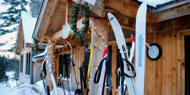 This December 2012 photo shows cross-country skis left by guests outside the Appalachian Mountain Clubs Gorman Chairback Lodge, a backcountry wilderness lodge near Greenville, Maine. In winter, visitors can reach the lodges and cabins only by cross-country skiing in. (AP Photo/Lynn Dombek)