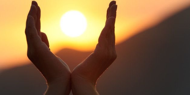 Decline in hands. A sunset on a background of the lifted female hands