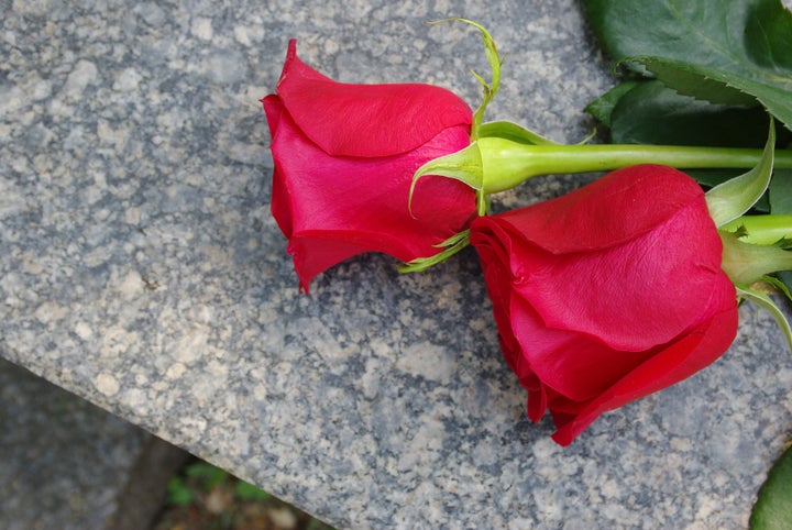 two red roses on a grave