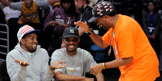 Kanye West, left, talks with filmmaker Spike Lee, right, and an unidentified friend before Game 3 of the NBA basketball finals between the Boston Celtics and Los Angeles Lakers on Tuesday, June 10, 2008, in Los Angeles. (AP Photo/Mark J. Terrill)