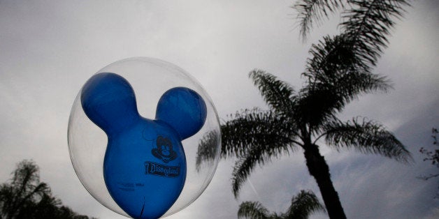 A man holds a balloon at Disneyland, Thursday, Jan. 22, 2015, in Anaheim, Calif. A major measles outbreak traced to Disneyland has brought criticism down on the small but vocal movement among parents to opt out of vaccinations for their children. (AP Photo/Jae C. Hong)