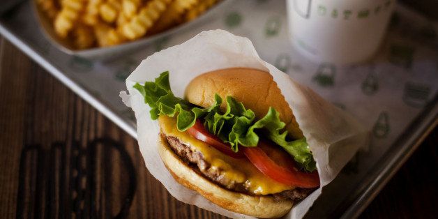 A burger, fries, and beverage are arranged for a photograph at a Shake Shack restaurant in New York, U.S., on Wednesday, Sept. 10, 2014. Shake Shack, the burger chain started by restauranteur Danny Meyer as a kiosk in a New York City park, is preparing for an initial public offering that could value it as high as $1 billion, people familiar with the matter said. Photographer: Michael Nagle/Bloomberg via Getty Images