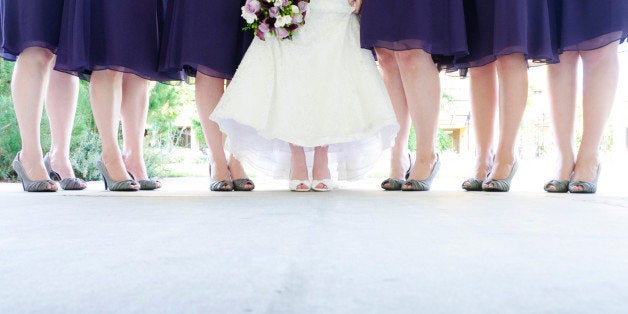 Six bridesmaid and bride standing.