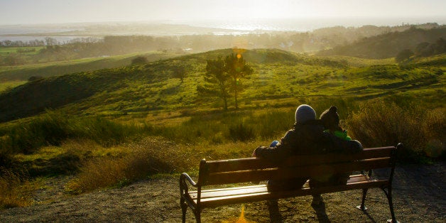 KLOSTER, GERMANY - JANUARY 02: Couple sitting on a bench on a hill and viewing over the Island Hiddensee January 02, 2015 in Kloster, Germany. Hiddensee is a car-free island in the Baltic Sea, located west of Germany's largest island, Ruegen, on the German coast. (Photo by Thomas Trutschel/Photothek via Getty Images)