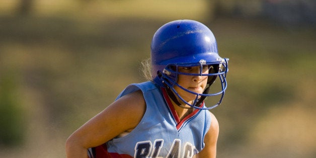 Girl (11-12) running on baseball diamond