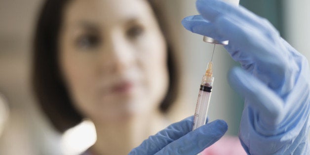 Female nurse filling syringe