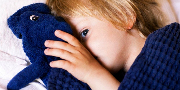 Boy lying in bed Sweden.