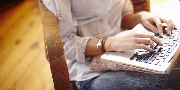 Young woman at home working on laptop