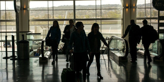 SAN FRANCISCO, CA - OCTOBER 17: Passengers arriving on a JetBlue Airways flight walk to the baggage claim area October 17, 2014 at the San Francisco International Airport in San Francisco, California. (Photo by Robert Nickelsberg/Getty Images)