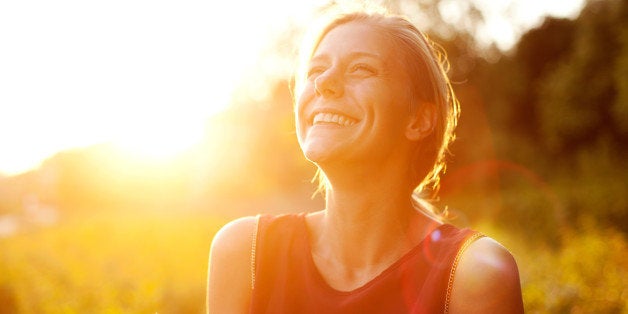 Young woman using smart phone at sunset