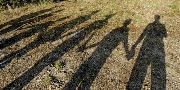 Shadows of family holding hands, elevated view