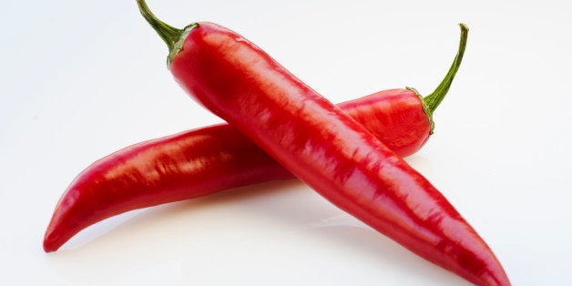 Close up of red chili peppers on white background