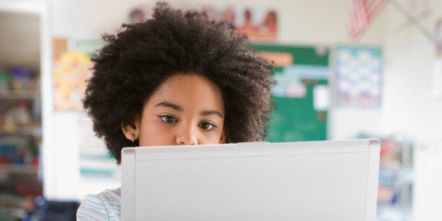Mixed race girl using laptop