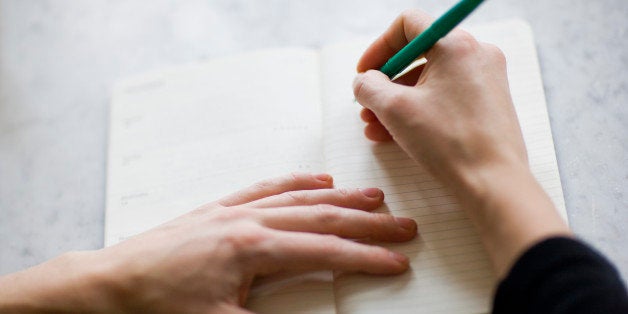 Woman writing on diary