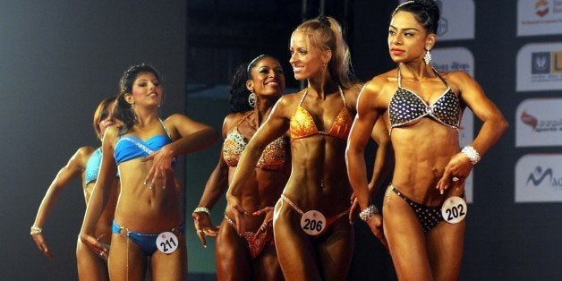 MUMBAI, INDIA - DECEMBER 7: Women bodybuilders showing their muscles during the 6th World Body Building and Physique Sports Championship at NESCO Ground on December 7, 2014 in Mumbai, India. (Photo by Sanjay Solanki/Hindustan Times via Getty Images)